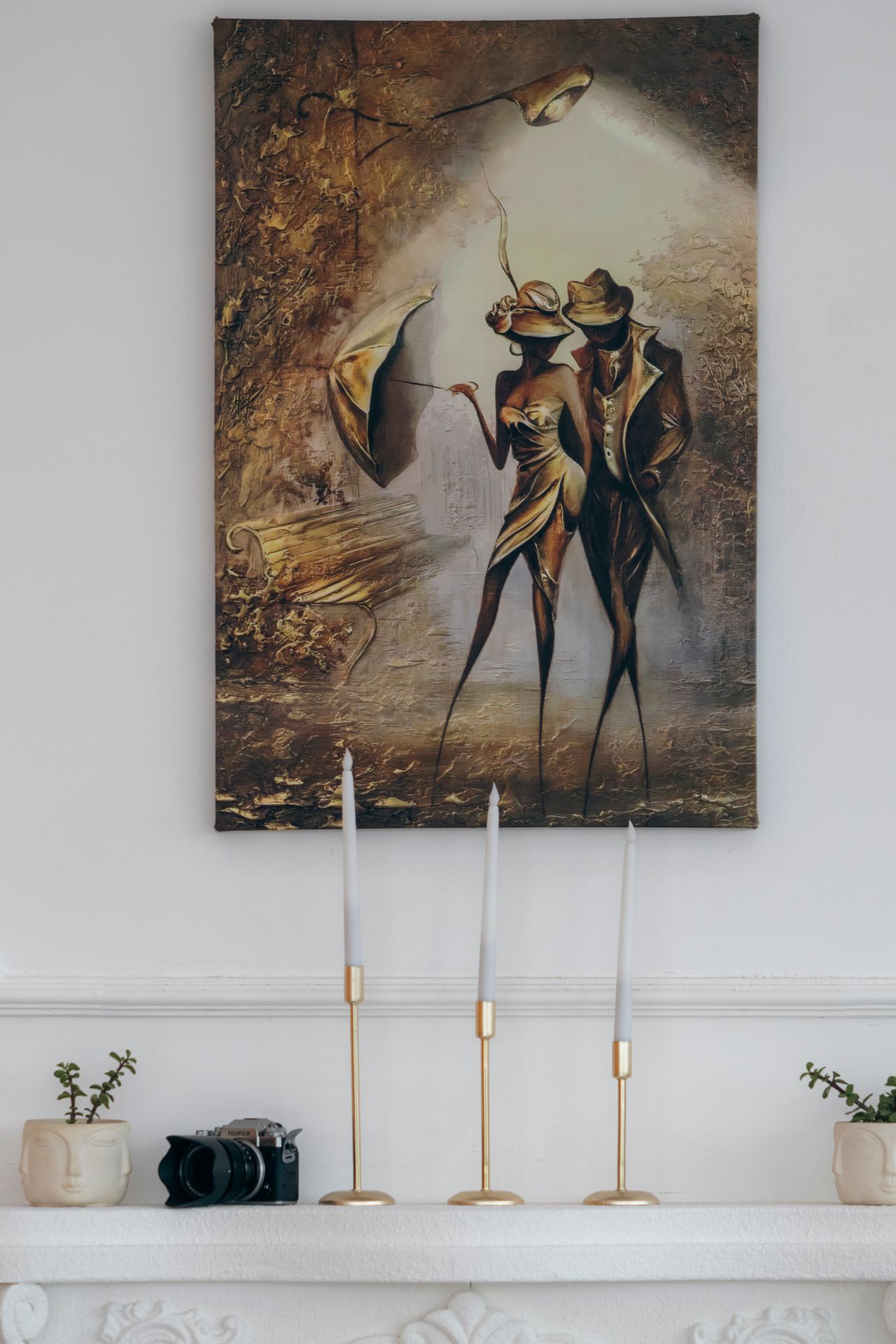 Painting hanging above a fireplace mantle in a home interior